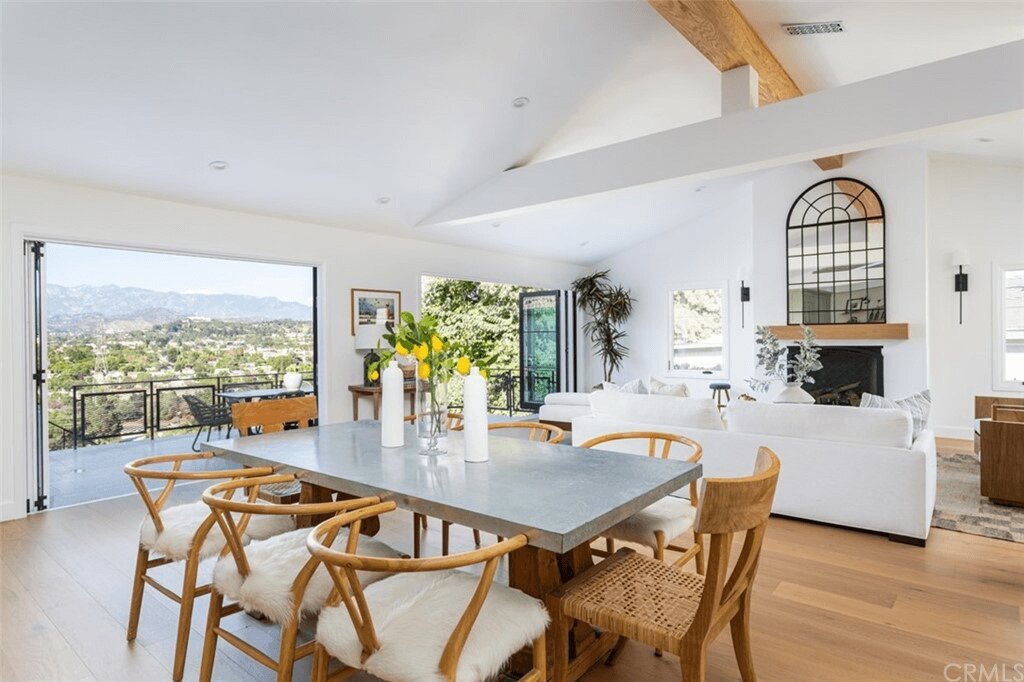 an open-concept dining room with a balcony designed by Los Angeles architects.
