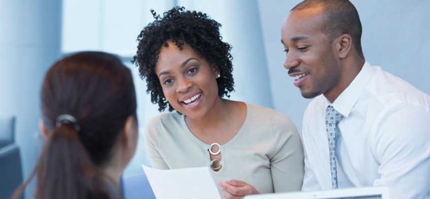 A couple smiling at their deal for architecture services