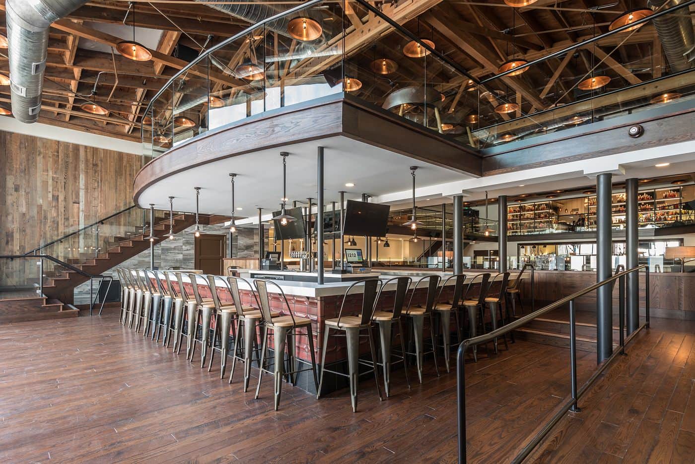 A dark wood indoor bar area designed by a commercial architect