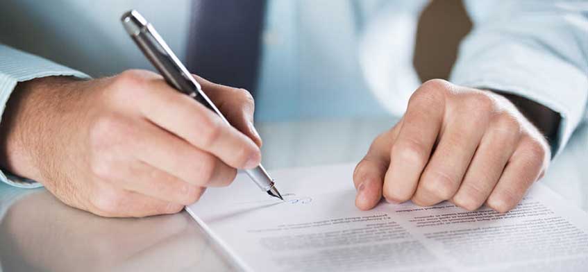 Man signing a deal for architecture services