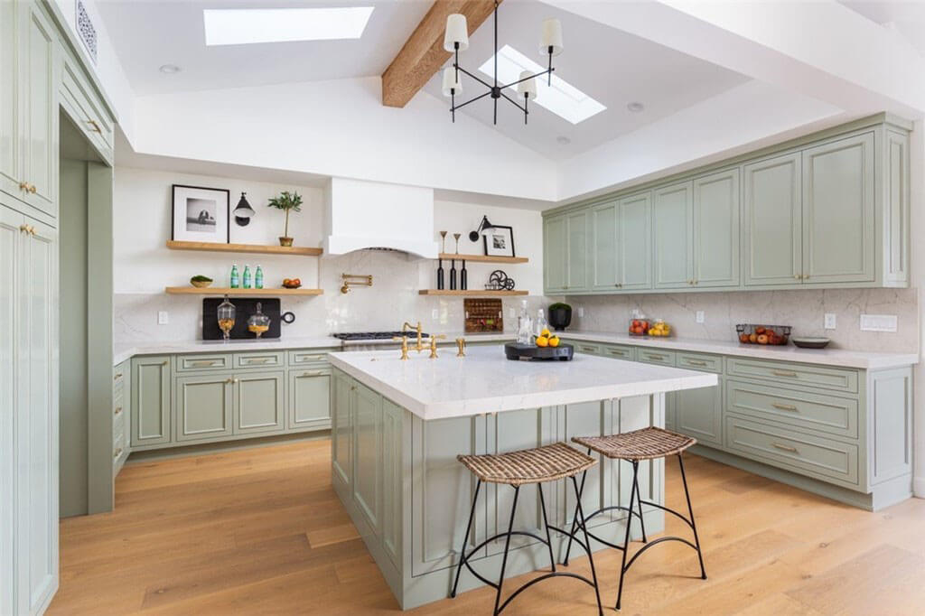 Kitchen with island and custom green cabinets