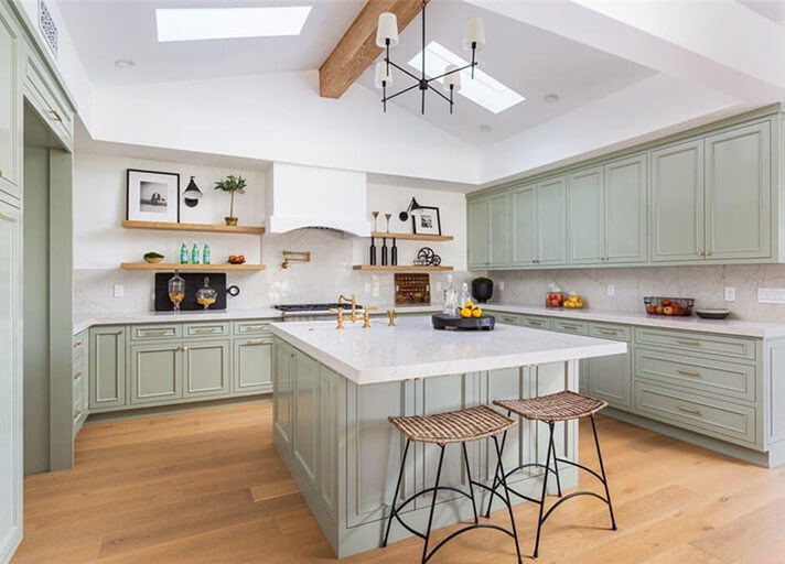 Kitchen with island and custom green cabinets