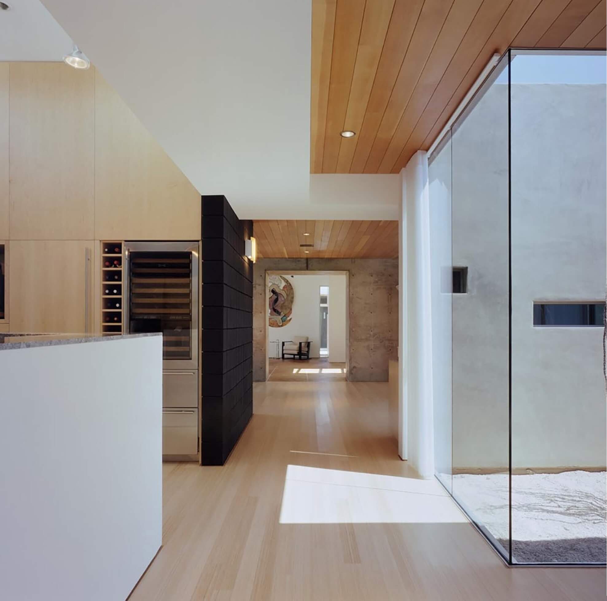 A remodeled kitchen area with wood flooring