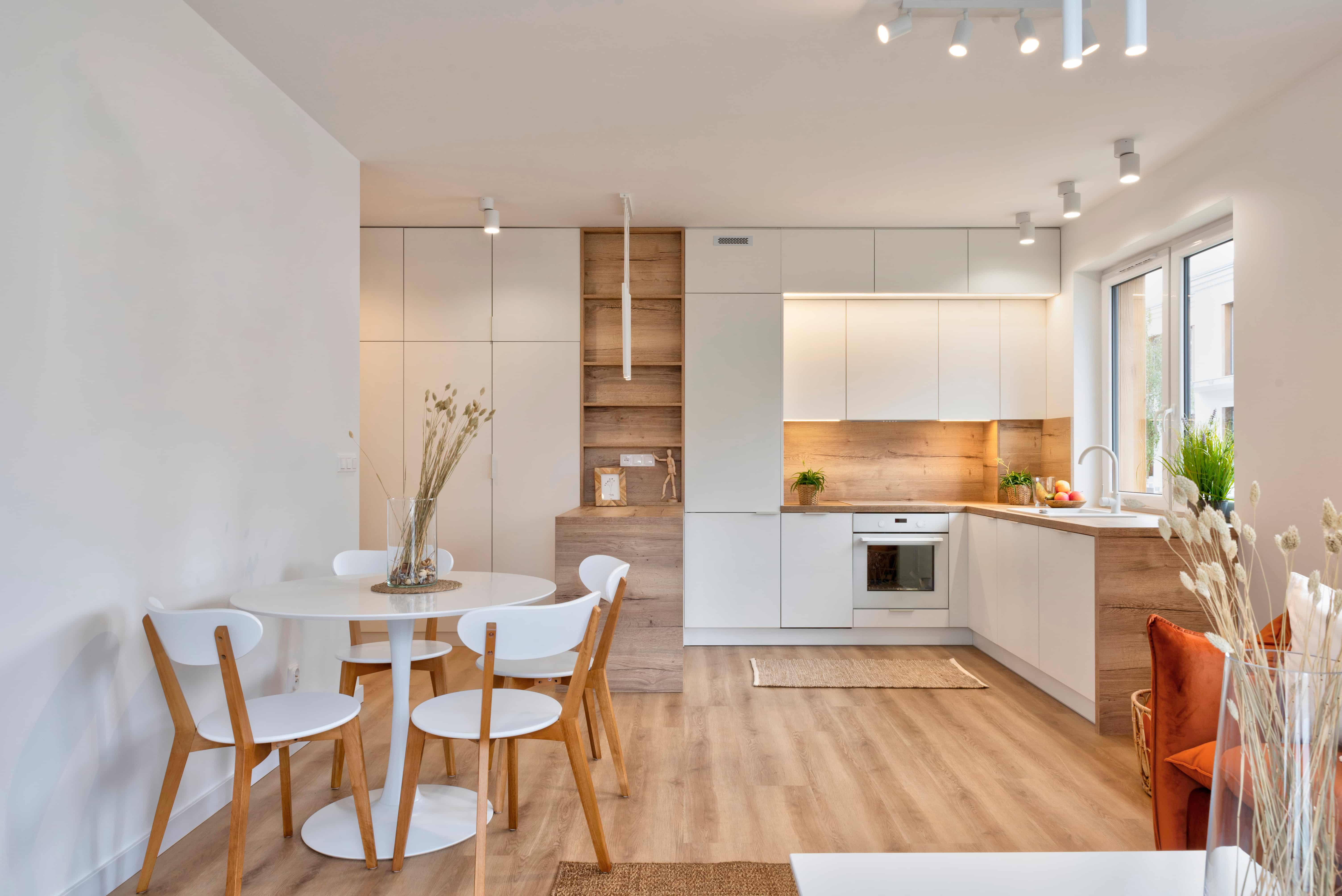 A white and wood kitchen designed by a multi-family architect