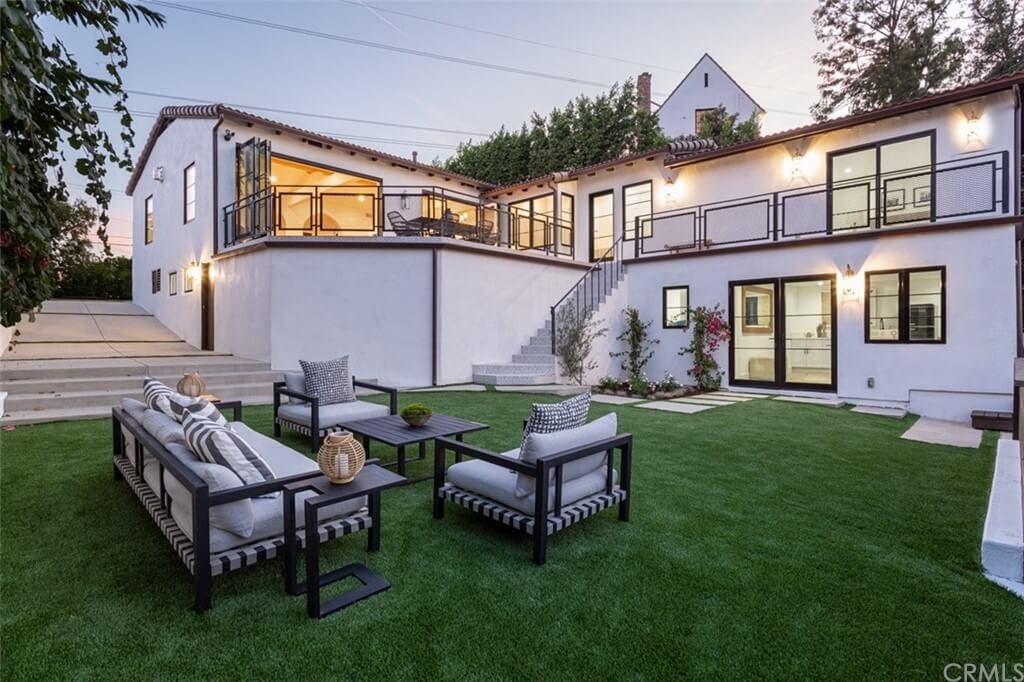 Modern white home exterior with lawn and patio
