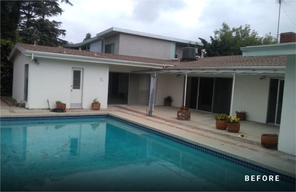 Outdated California mid-century modern home backyard with a pool