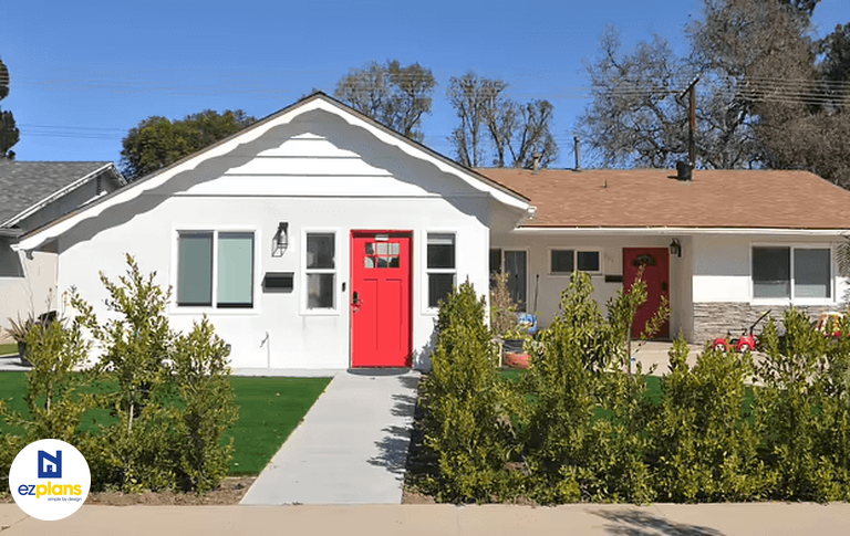 Garage conversion to an ADU with a red front door.