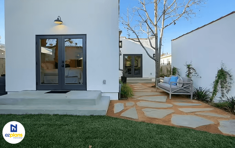 An attached ADU conversion with an addition to the main home designed to comply with ADU laws and regulations.