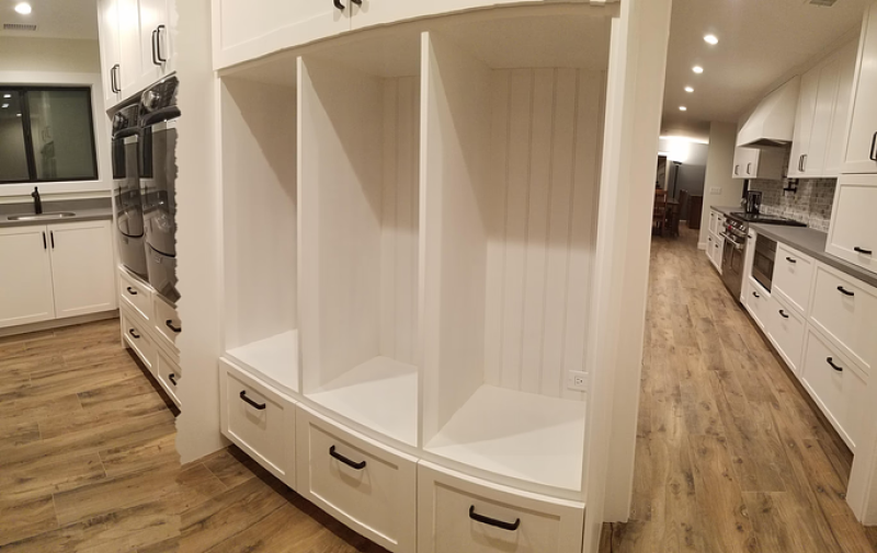white storage area with integrated washer and dryer